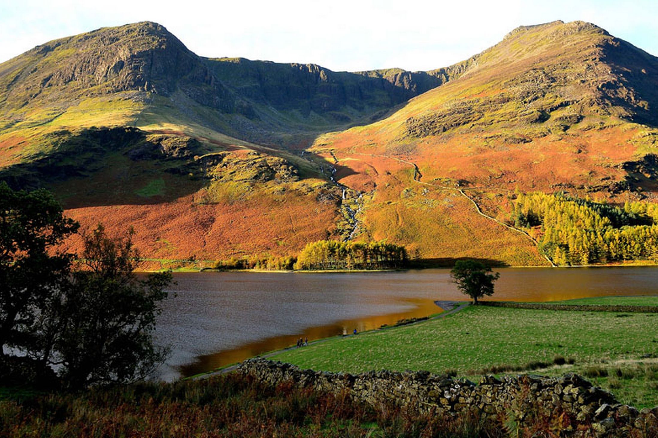 The-sun-picks-out-the-Autumn-colours-on-the-peaks-near-Buttermere-lake-in-Cumbria-24th-October-2641170